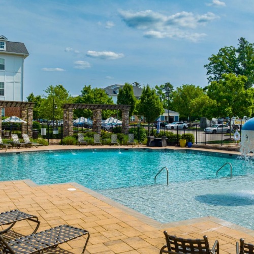 a pool with chairs around it