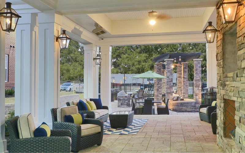 a patio with chairs and tables